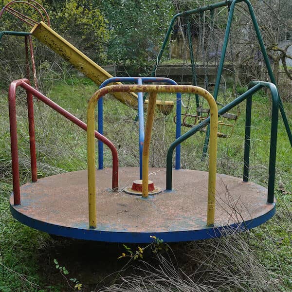 old worn outdoor merry-go-round before playset removal