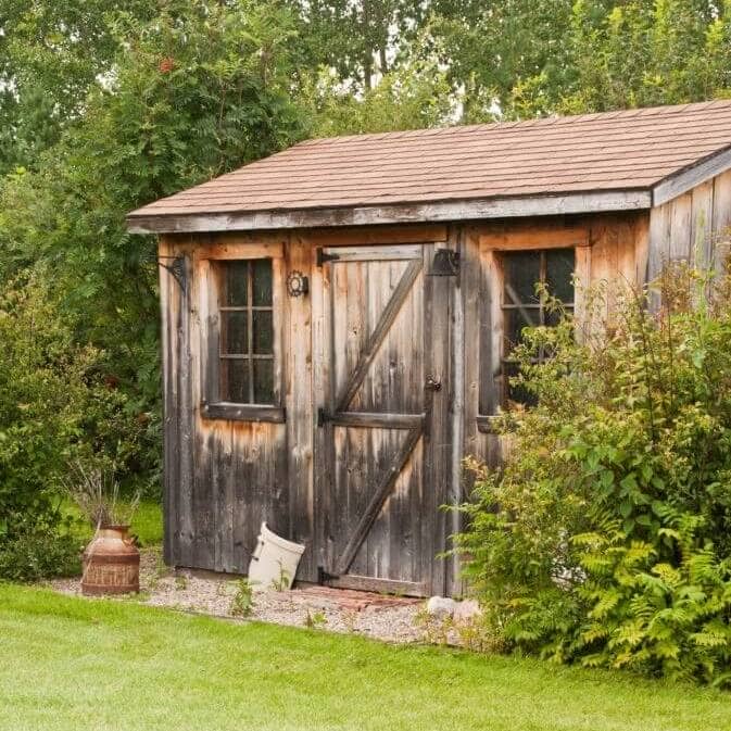 An old wooden shed in a backyard for shed removal