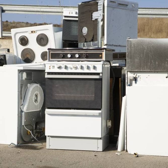 piles of old appliances abandoned on road
