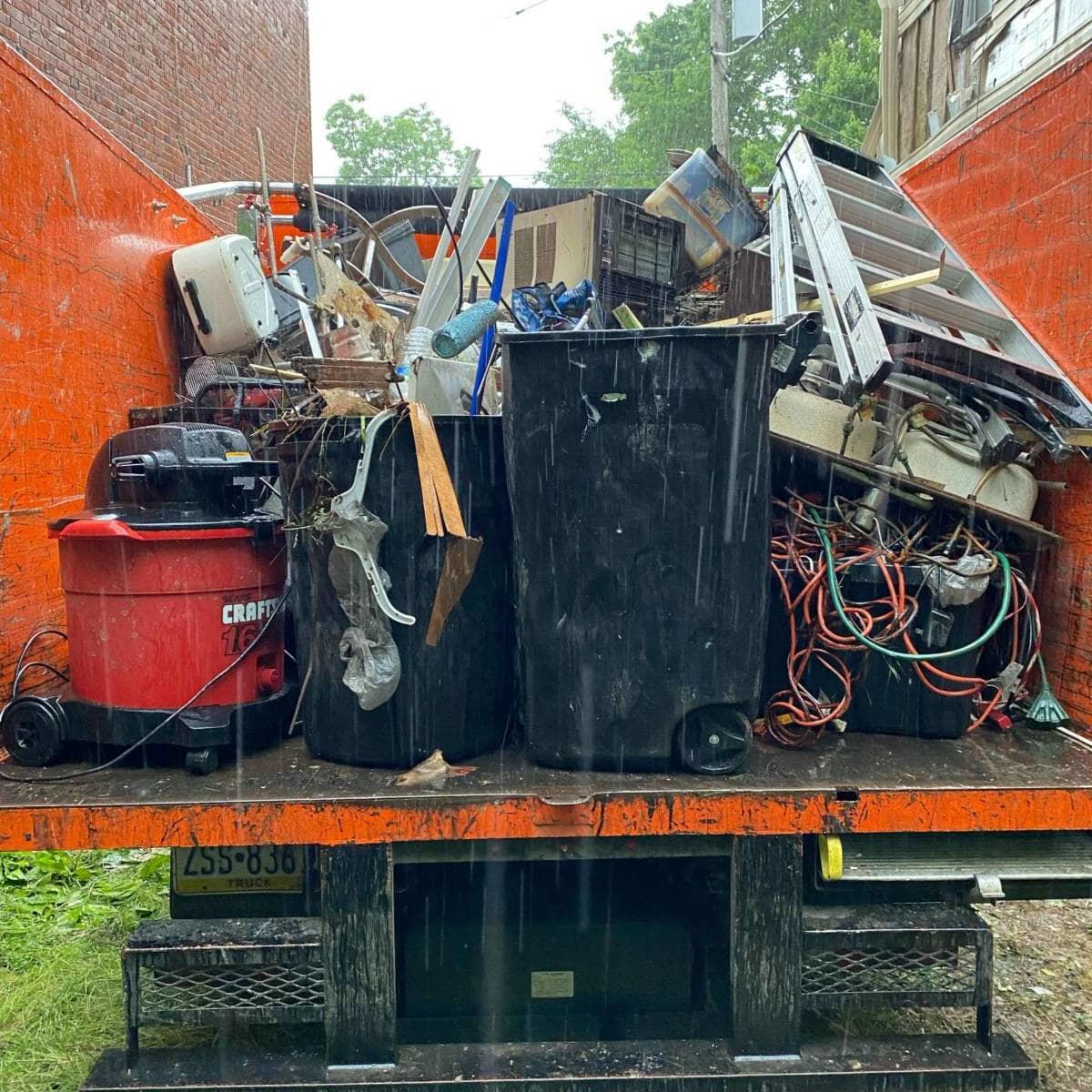 junk collected in orange trunk while raining