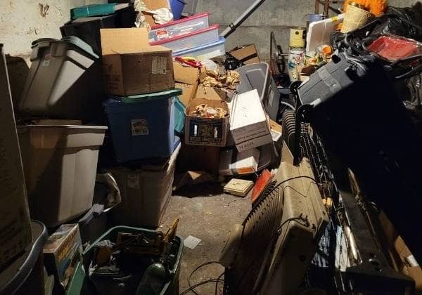 cluttered basement in Philadelphia with boxes and junk stacked to the ceiling