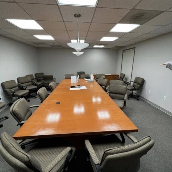 philadelphia-office-cleanout large conference room table and scattered chairs in messy conference room